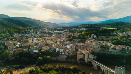 Obraz premium Aerial drone panorama of Besalu medieval town with historic stone bridge and mountain landscape in Catalonia Spain