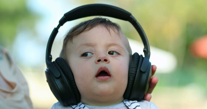 Baby with heaphones listening to music for first time