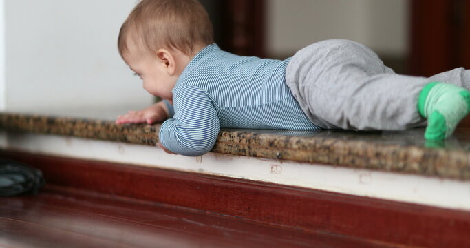 Baby infant learning to climb down step. Toddler development