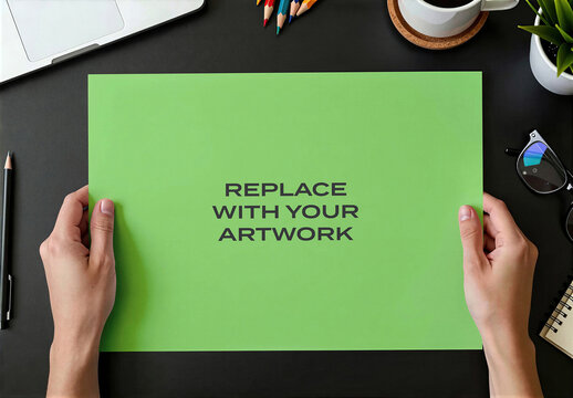 Paper mockup on a black desk with laptop, coffee cup, pencils, and glasses, realistic office workspace presentation for branding, advertising or editorial content