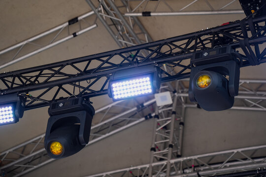 Professional stage lighting rig mounted on aluminum trussing featuring moving head spots and LED strobe light fixtures for event production