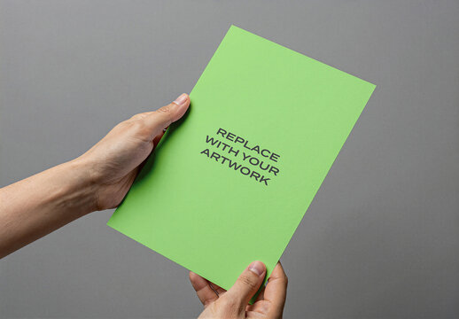Paper mockup held by hands against gray background, realistic print presentation template for artwork, stationery branding, graphic design display, brochure