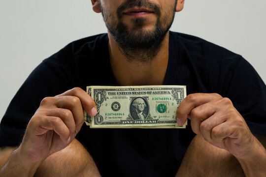 A young man takes out a loan from a state-owned bank to study or pay off a mortgage. The thief guy counts the paper money he stole from tourists at the resort. old-style American paper bills