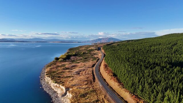 Aerial drohne view of scenic highway along Lake Pukaki with mountains background, South Island, New Zealand.