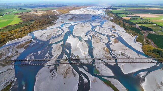Aerial drone view of the main highway and railway bridges over the Rakaia River, New Zealand. A scenic bird&rsquo;s-eye view showcasing transport infrastructure, a wide river and the natural landscape.	