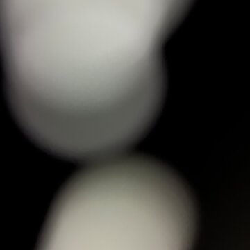 Abstract blurred spheres on dark background with soft light