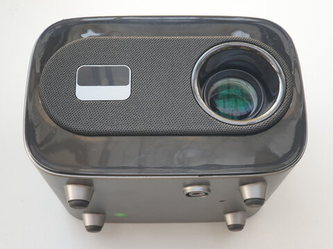 Compact Black Multimedia Projector with Speaker and Lens on White Background