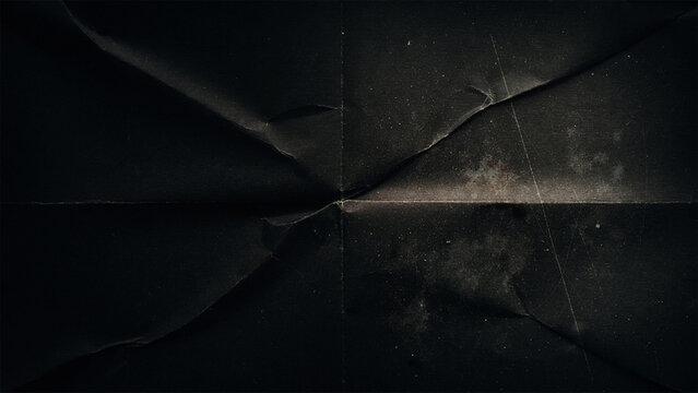 Dark folded paper background with grunge texture and scratches, abstract distressed surface, aged material for design overlays, subtle dust and grit
