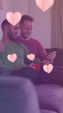 Animation of heart icons over happy diverse gay couple embracing
