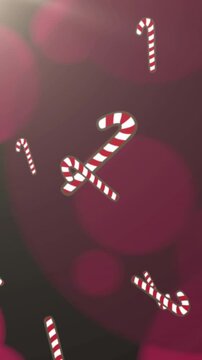 Animation of christmas candy canes falling and pink spotlights on black background