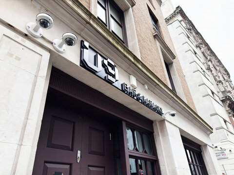 Exterior U9 Bar and Karaoke entrance of a London UK building with CCTV cameras and modern security signage