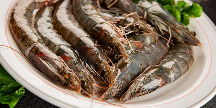 Raw prawns crustacean large shrimp (gambas) fresh seafood pescetarian diet food preparation tasty snack fresh and delicious gourmet food background on the table rustic food 