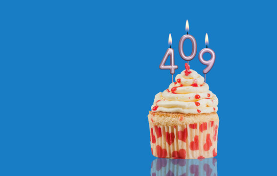 Birthday Or Anniversary Cupcake With Lit Candles; Candles Forming The Number 409