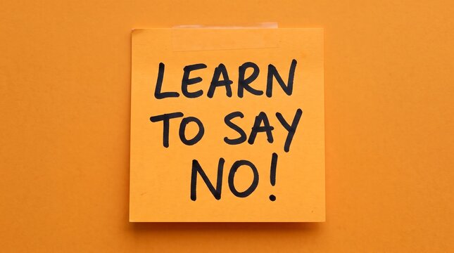 Learn to say no handwritten text on sticky note. Motivational message on yellow paper. Assertiveness and boundaries concept for mental health.
