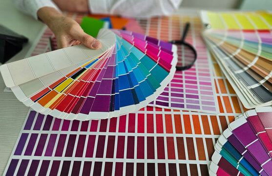 Color matching process with color swatches and design elements on a table concept