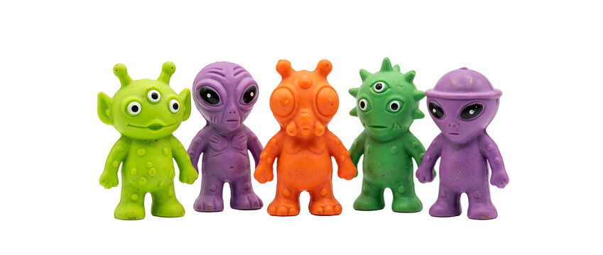 Alien toy figures colorful monsters standing row on black background set cute retro sci-fi space character plastic rubber extraterrestrial creature mascot collection concept pop culture figurine art