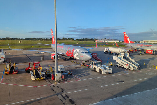 Jet2 passenger aircraft on apron at Leeds Bradford Airport, UK, with stairs, baggage equipment and ground service vehicles during summer operations: Leeds, UK - August 8, 2025