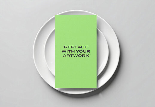 Vertical brochure mockup on stacked white plates, top-down view of stationery presentation with placeholder card, Template, minimalist table setting for branding and print design display