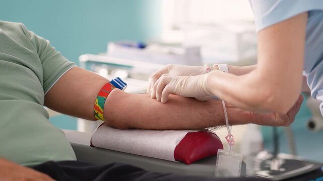 Nurse collecting blood from a patient during donation process