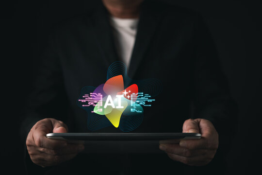 Businessman hands holding tablet with colorful glowing AI hologram and circuit lines. Concept of artificial intelligence, machine learning, modern business technology, and future digital innovation.
