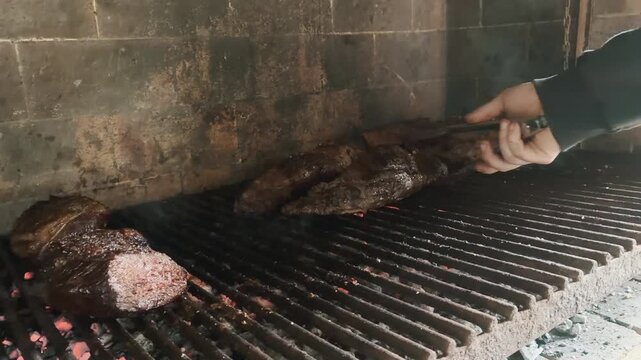 Fire Burning Under the Grill &ndash; Traditional Argentine Asado with Beef and Sausages