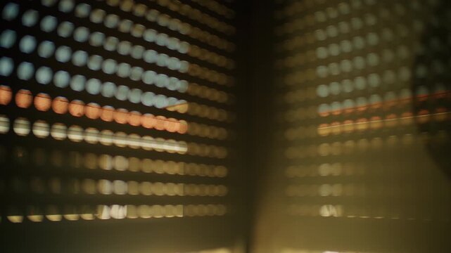 Sunlight filtering through closed blinds, forming abstract horizontal patterns on a window and wall, creating a dark mood