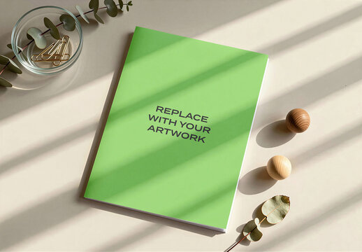 Vertical poster mockup displayed on an interior wall with natural window light, wooden floor and indoor plant, contemporary graphic design presentation, printable template