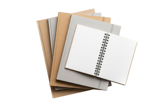 Stack of spiral notebooks and paper pads on a desk isolated on transparent background