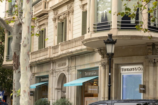Barcelona, Catalonia, Spain, September 10 2025 Tiffany & Co. Storefront On Elegant Historic Building Facade With Turquoise Awnings And Street Lamp