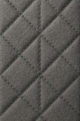 Fototapeta premium Luxury automotive leather background showing precise diamond quilting