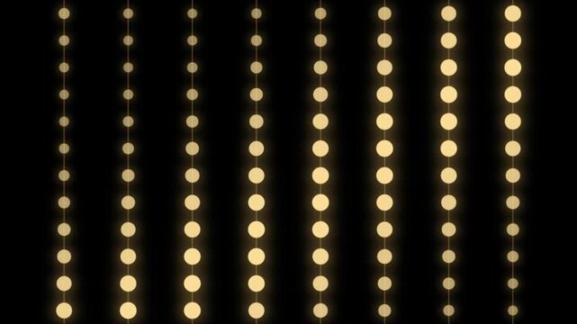 Abstract golden light beads falling in vertical rows against black backdrop for stage event motion.