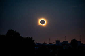 Fototapeta premium Total solar eclipse totality, Valencia, Spain, above a silhouette foreground