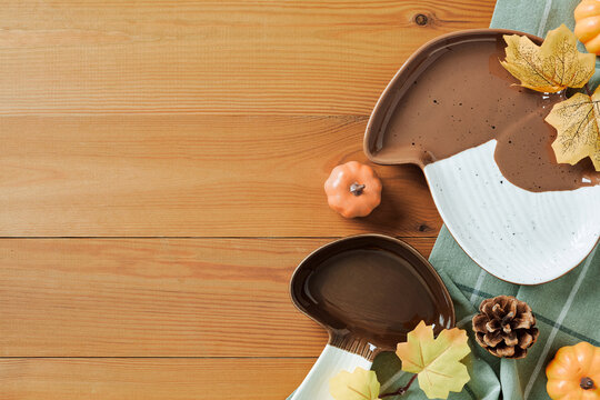 Autumn ceramic mushroom plates on wooden background with decor. Flat lay, top view, copy space