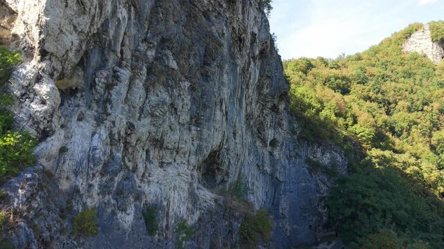 Drone Ascending Along Rock Face at Dariva Climbing Spot Revealing Sarajevo Neighborhood, Bosnia and Herzegovina