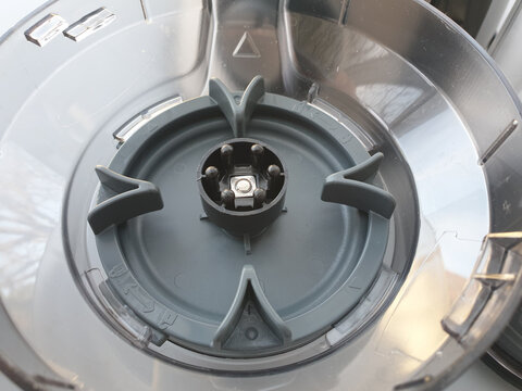 Detailed view of a grey plastic blender component with locking mechanism