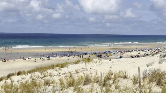 Le Porge, Gironde, France - August 2026: Tourists fill the Atlantic beach a few weeks after the wildfire, showing the return of summer tourism to the coastal resort.