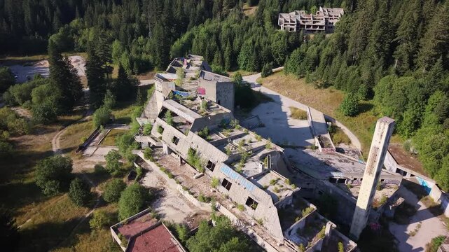 Aerial View of Destroyed Hotel Igman Abandoned Ruins with Trees Growing Through Slanted Windows, Bosnia and Herzegovina
