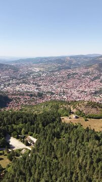 Aerial View of Sarajevo Valley and City Skyline Overlooking Forested Slopes from Trebevic Mountain, Bosnia and Herzegovina