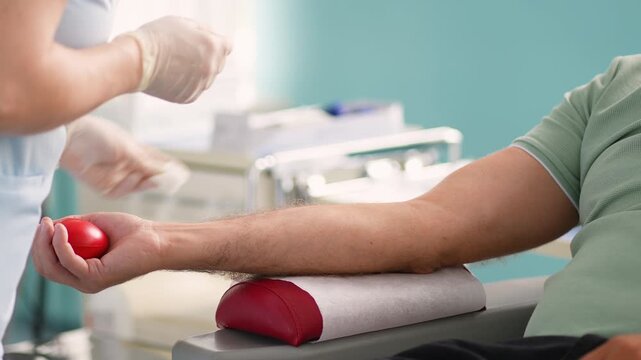 Nurse preparing patient arm for blood donation or transfusion