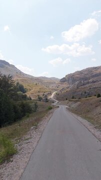 Drone Flying Along Mountain Road and Ascending Over Visocica Landscape, Bosnia and Herzegovina