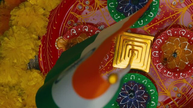 Indian flag waving over a colorful diwali celebration plate