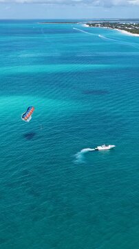 Parasail In Providenciales Overseas Territory Turks And Caicos Islands. Bird Eye View Of Stunning Parasailing Scene Over A Blue Ocean.