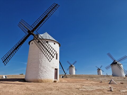 Iconic Spanish windmills standing on a dry hill in Campo de Criptana, Castilla-La Mancha