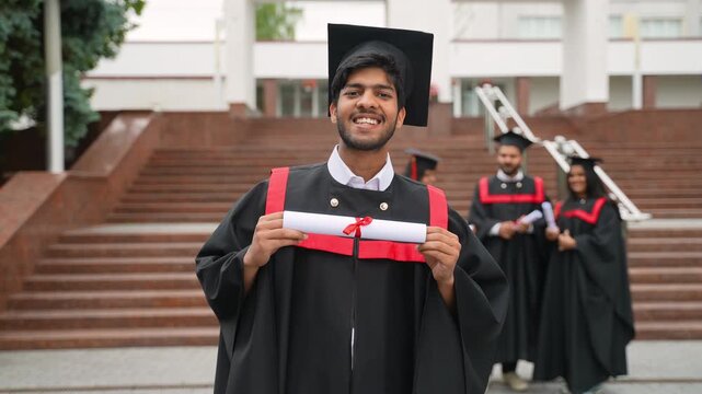 Proud indian graduate student holding diploma