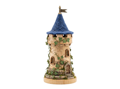 Miniature fantasy castle tower model with blue felt roof and ivy vines isolated on black background, handcrafted fairy tale fortress sculpture for whimsical story concepts and magical decor.