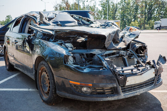 Car accident wreck collision crash damage vehicle safety insurance salvage concept, showing crushed roof, destroyed front end, exposed engine and severe impact aftermath.