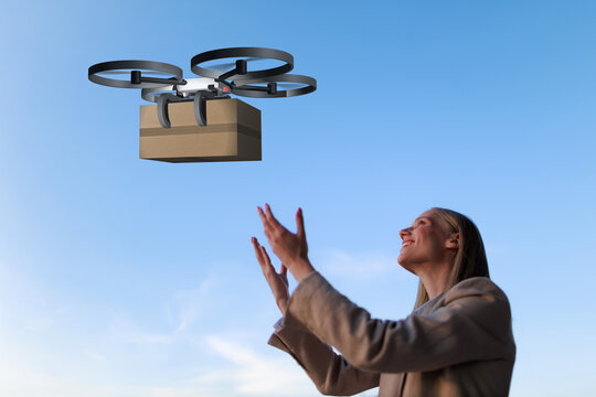 Businesswoman receives drone delivery package in the city