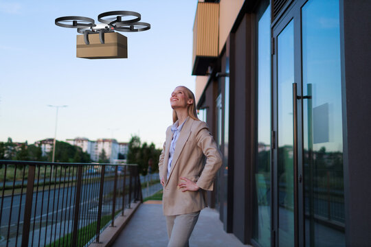 Businesswoman receives drone delivery package in the city