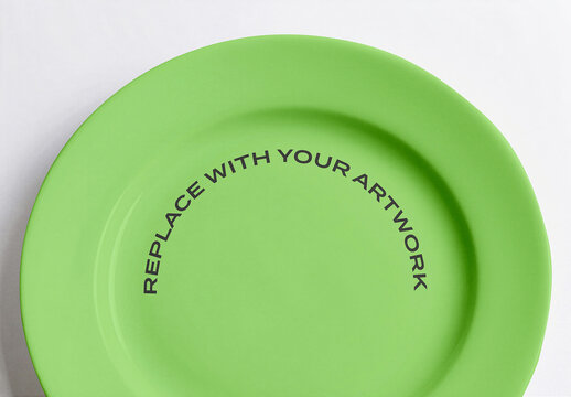 Ceramic plate mockup with placeholder text for artwork, top-down view on white surface, graphic design presentation, print template, branding display, food packaging