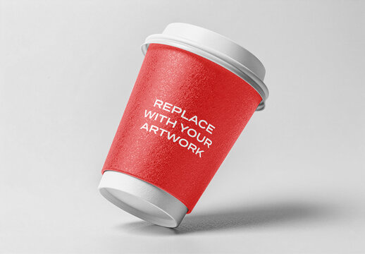 Paper coffee cup mockup with white lid and base tilted on a light gray surface, realistic packaging presentation for branding print advertising, template product display